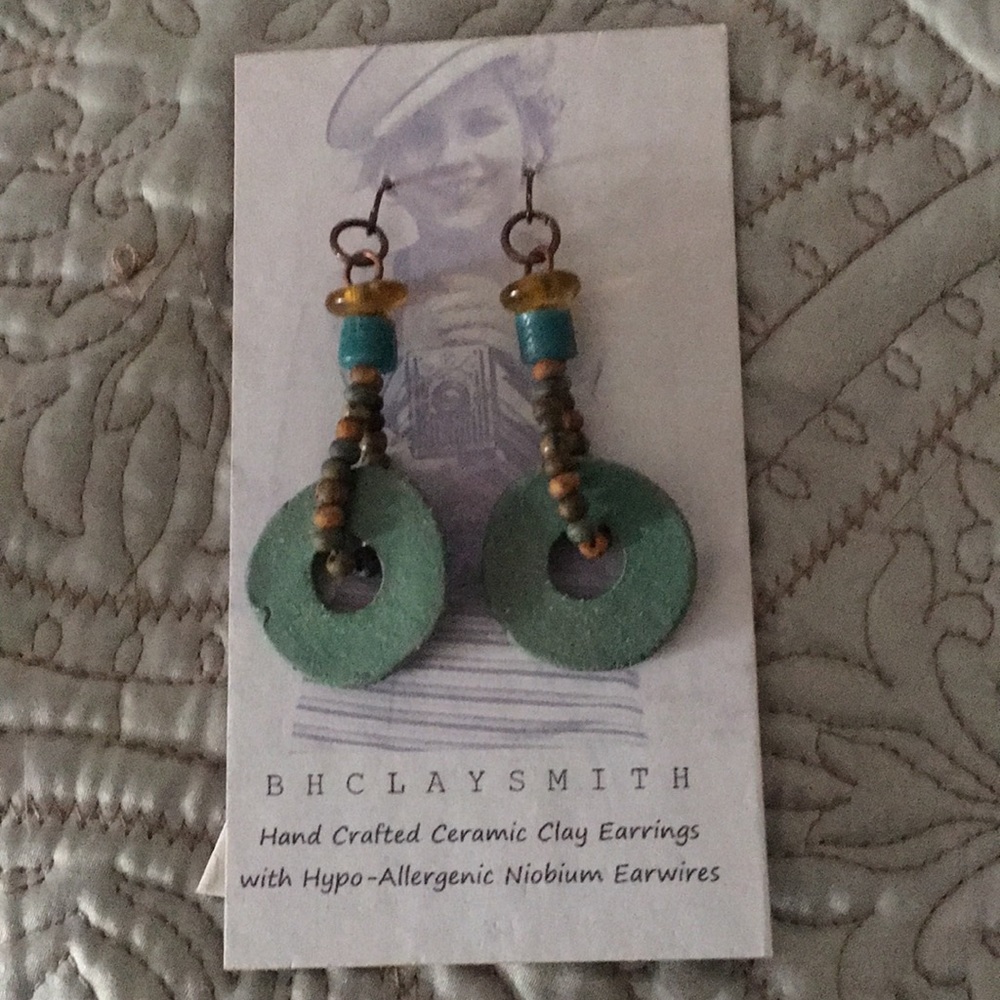 Hand crafted ceramic clay earrings. Teal disc.